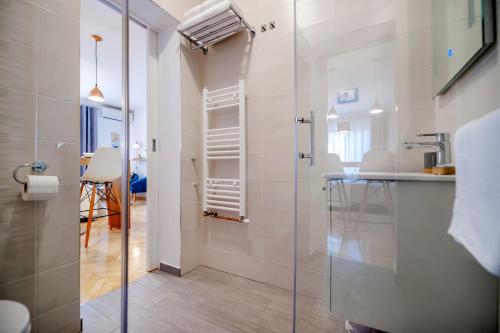 a bathroom with a glass shower and a sink at Studio Apartment Noah in Rovinj