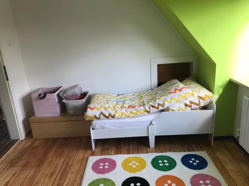 a small bedroom with a bed and a rug at Ferienhaus im Sandkamp in Westensee
