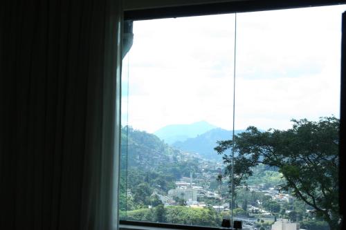 a view of a city from a window at Hotel Dominguez Master in Nova Friburgo