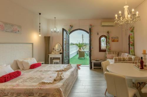 a bedroom with a bed and a table and a dining room at Olympus Studios in Malia