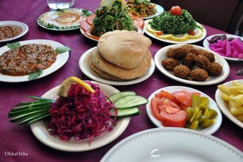 a purple table with plates of food on it at La Casetta in Nazareth