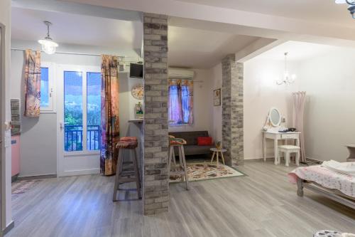 a living room with a ladder in the middle of a room at Olympus Studios in Malia