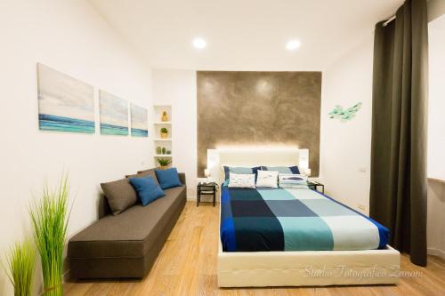 a bedroom with a bed and a couch at Sea House Porto Ercole in Porto Ercole