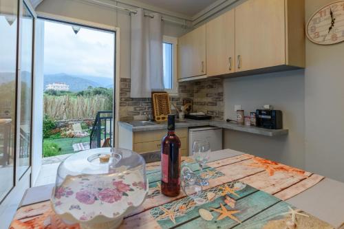 a bottle of wine sitting on a table in a kitchen at Olympus Studios in Malia