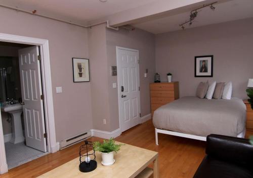 a bedroom with a bed and a table in a room at Stylish Downtown Studio in the SouthEnd, C.Ave# 2 in Boston