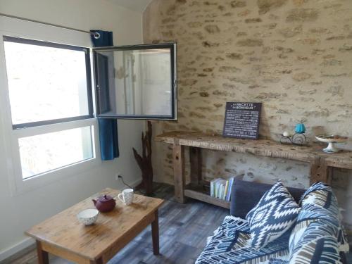a living room with a couch and a table at La Maison Mescladis in Manhac