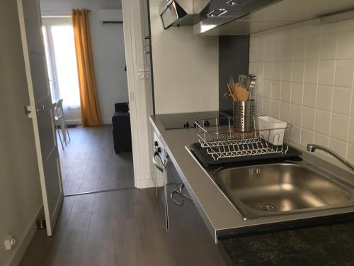 a kitchen with a sink and a counter top at Gîte du Petit Poucet in Saint-Hilaire-de-Riez