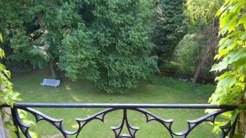 a park with a bench in the grass at Château de la Vernède, la Grande Vernède in Saint-Rémy-de-Chargnat