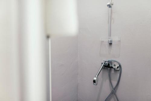 a shower in a bathroom with a shower head at Wake Up Wellness Hostel in Brno
