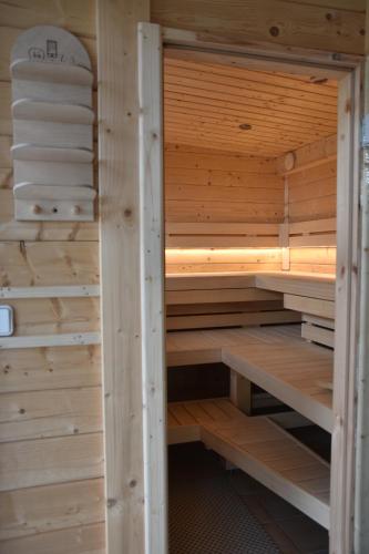 a wooden sauna with wooden shelves and towels at Seehaus Hartwigsdorf in Klein Vielen