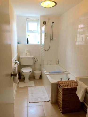 a bathroom with a tub and a toilet and a sink at Be My Guest Liverpool in Liverpool