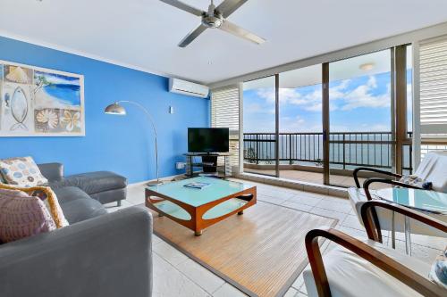 a living room with a couch and a tv at Seaview Resort in Mooloolaba