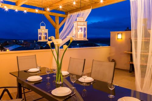 a dining room with a table and a view of the city at Apartamento Ático Bardenas in Arguedas