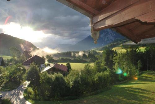 a painting of a house in a valley with mountains at Almbauernhof in Ruhpolding