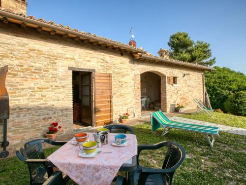 a table and chairs in front of a house at Apartment in Sant'Angelo near Medieval Town in SantʼAngelo in Vado