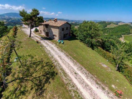 an old house on a hill with a dirt road at Apartment in Sant'Angelo near Medieval Town in SantʼAngelo in Vado