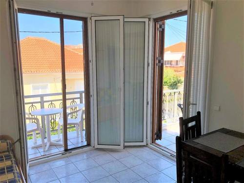 a room with sliding glass doors leading to a balcony at Mythos Suites-Apollo apartment in Methoni