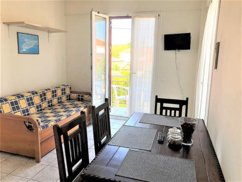 a living room with a dining table and a couch at Mythos Suites-Apollo apartment in Methoni