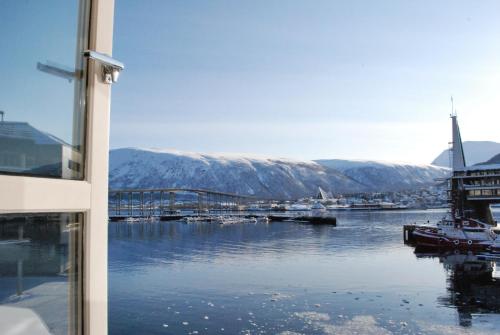 a view of a body of water with a bridge at Clarion Collection Hotel With in Tromsø