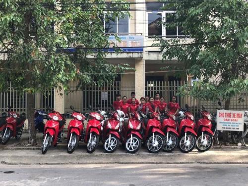 a group of motorcycles parked in front of a fence at Peaceful House Hostel in Dong Hoi