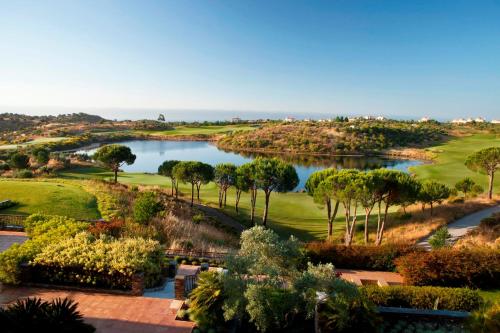 a view of a golf course with a lake at Monte Rei Golf & Country Club in Vila Nova de Cacela