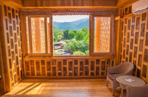 a room with a window with a view at Santhiya Koh Chang Resort in Ko Chang