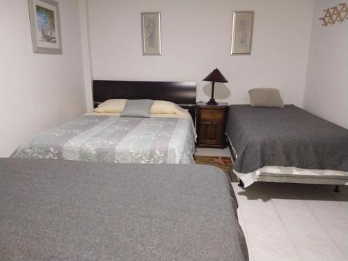 a bedroom with two beds and a dresser in it at Casa De Polita in San Andrés