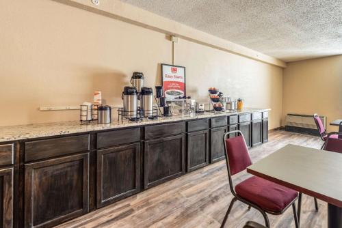 a kitchen with a large counter top and wooden cabinets at Econo Lodge in Brainerd