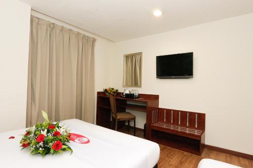 a hotel room with a bed with flowers on it at My Hotel @ KL Sentral in Kuala Lumpur