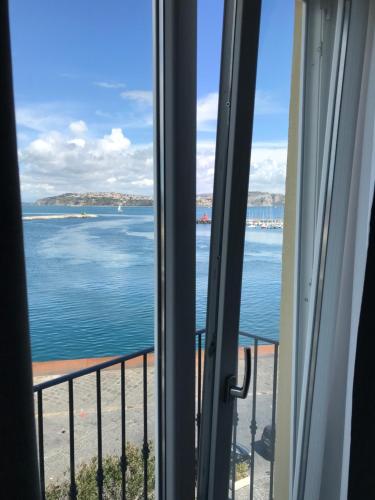 a view of the ocean from a window at Vento di mare in Procida