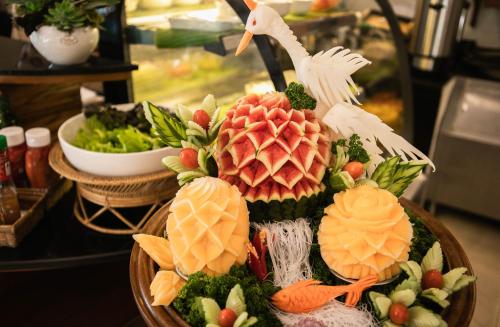a plate of food with a statue of a crane at Pingviman Hotel in Chiang Mai