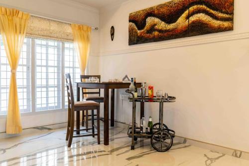 a dining room with a table and chairs at StayVista at Aashirwaad Villa in Coonoor