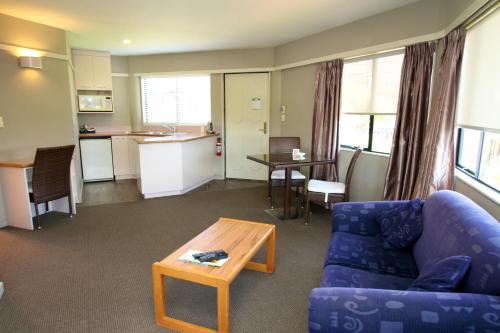 a living room with a couch and a table at The Beachcomber Hotel in Nelson