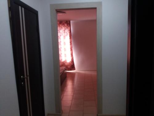a hallway with a pink bathroom with a pink shower at ЧистоСила in Uzhhorod