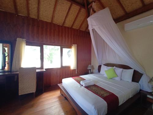 Кровать или кровати в номере Balenta Bungalow Gili Trawangan