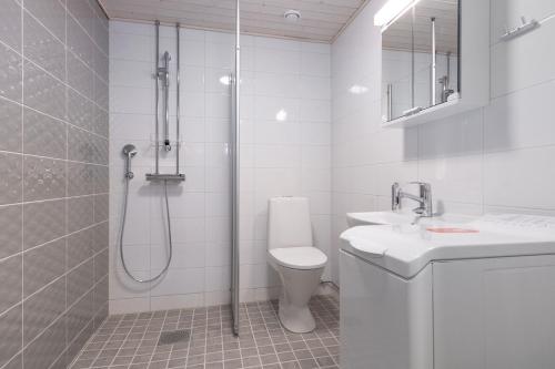 a bathroom with a shower and a toilet and a sink at Forenom Serviced Apartments Rauma Kaivopuisto in Rauma