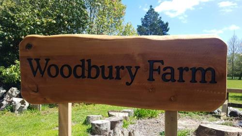 a wooden sign for a woodbury farm at Woodbury Farm in Takanini