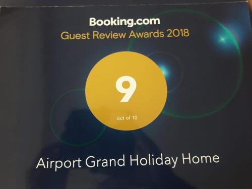 an airport grand holiday home sign with a yellow circle at Airport Grand Holiday Home in Katunayake