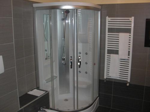 a shower with a glass door in a bathroom at Hotel Legnano in Legnano