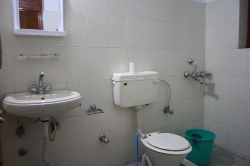 a bathroom with a toilet and a sink at Hotel Khan Manzil in Leh