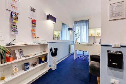 an office with a desk and a computer in a room at Easy Budget Colosseo in Rome