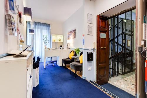 an office with a blue carpeted floor and a door at Easy Budget Colosseo in Rome