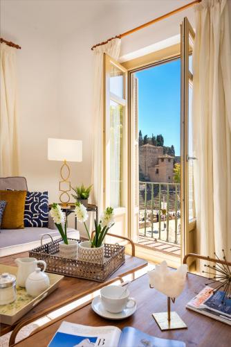 a living room with a table and a large window at Genteel Home Zegrí in Málaga