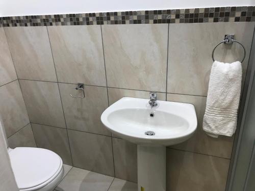 a bathroom with a sink and a toilet at Fama Lodge Single Rooms in Cape Town