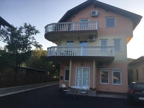 a building with a balcony on the side of it at Amina River Apartment in Bihać