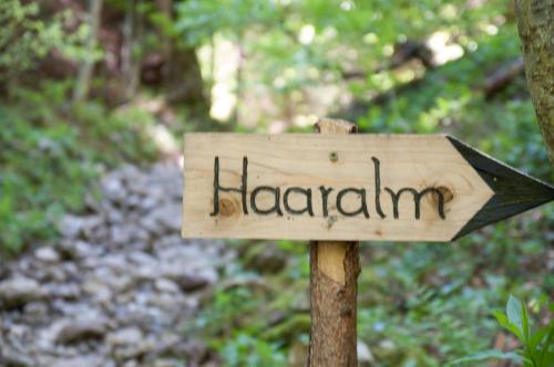 a sign that says hazard on a trail at Almbauernhof in Ruhpolding