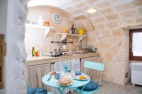a small kitchen with a table with food on it at Dimora Porto Canale in Monopoli