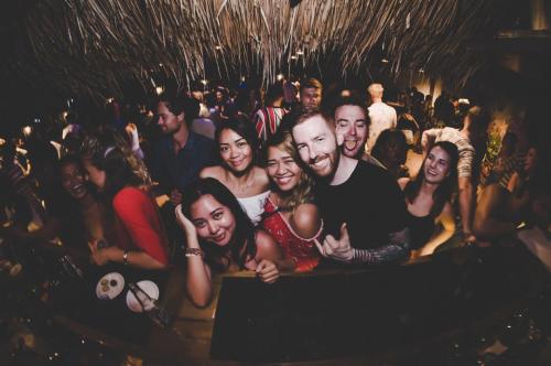 a group of people posing for a picture at a party at Mad Monkey Hostel Siargao in General Luna
