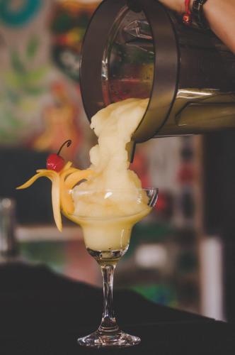 a drink being poured into a wine glass at Mad Monkey Hostel Siargao in General Luna