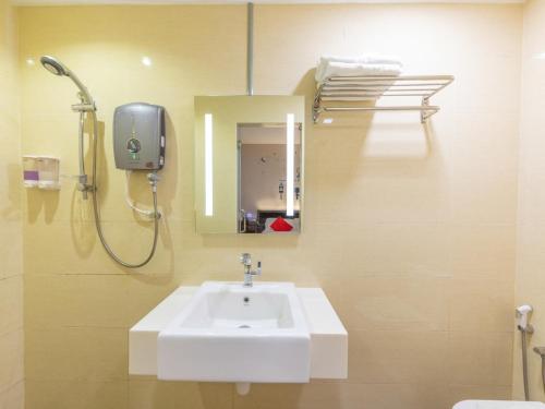 a bathroom with a sink and a shower and a mirror at Sunlight Hotel Kulai in Kulai
